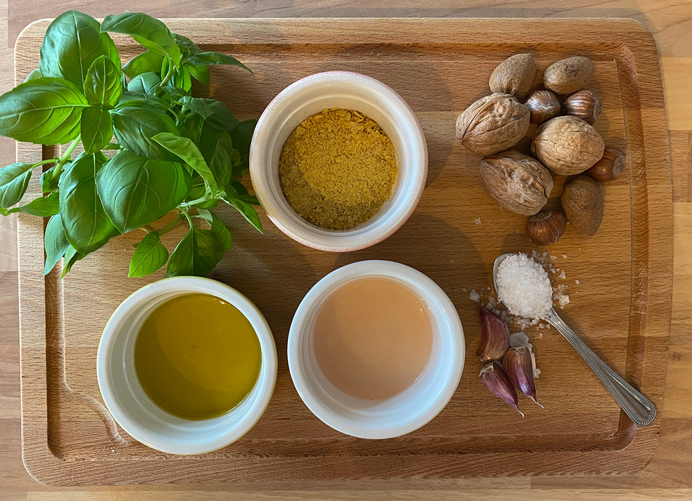 A chopping board with vegan pesto ingredients
