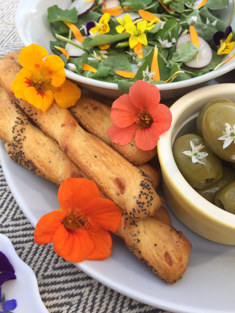 Nasturtiums, garlic chives with olives and edible flowers salad