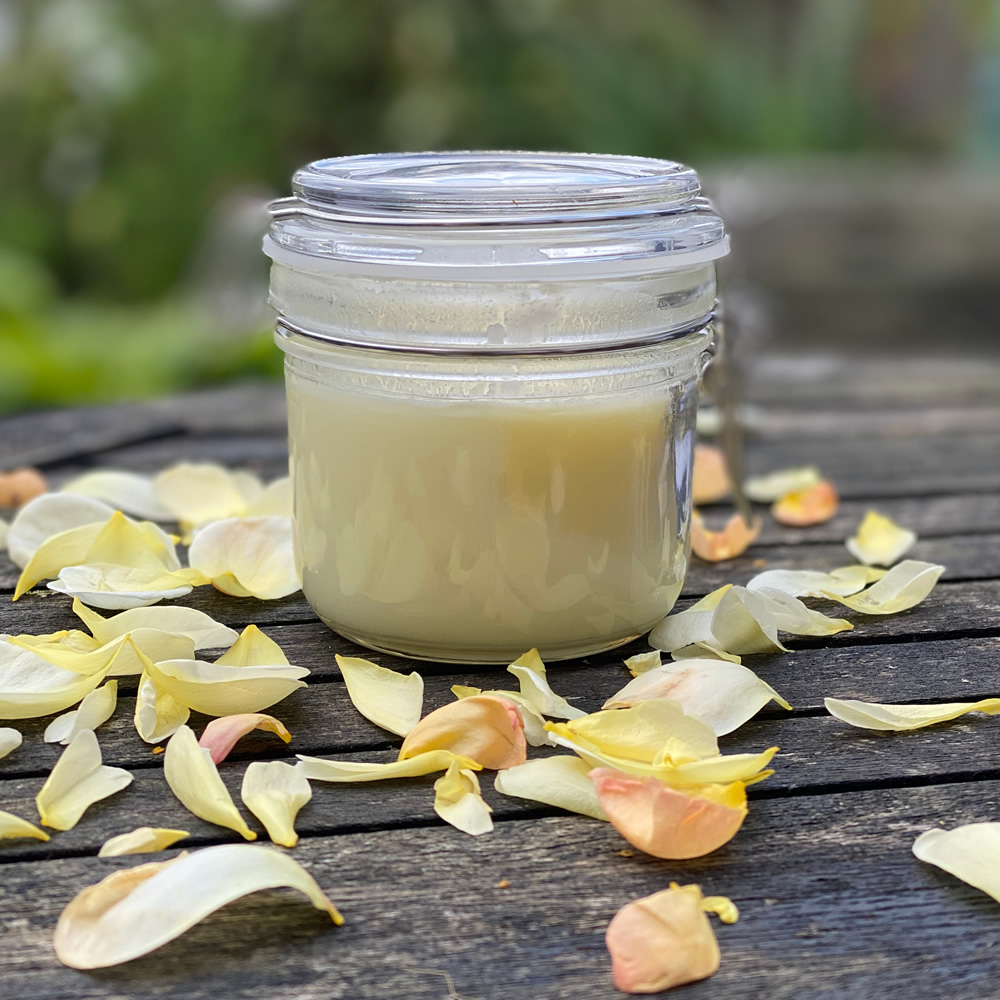 A jar of hand salve on a wooden table